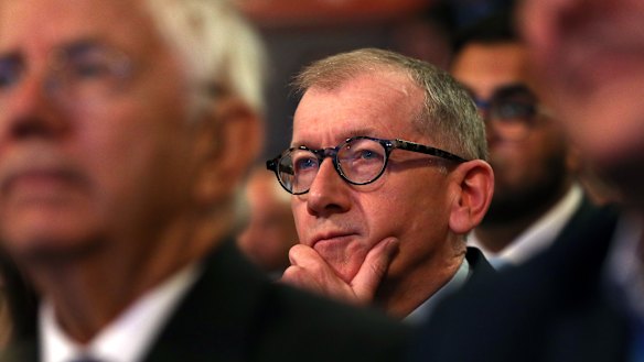 Theresa May's husband, Phillip, watches her deliver a speech to the Conservative Party conference.