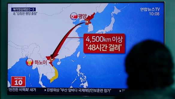 A woman watches a TV news program reporting about North Korean leader Kim Jong Un's departure for Vietnam at the Seoul Railway Station in Seoul, South Korea, on Sunday.