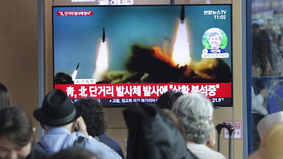 People watch a TV showing a file footage of North Korea's missile launch in Seoul on Saturday.