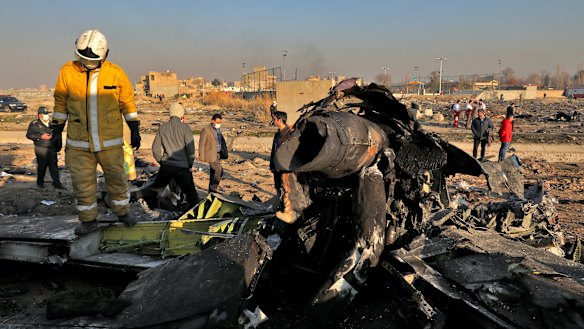 Rescue workers search the scene where a Ukrainian plane crashed in Shahedshahr, near the Iranian capital Tehran on Wednesday.