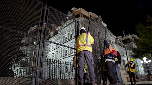 Construction workers set up additional fencing near the White House ahead of election day. 