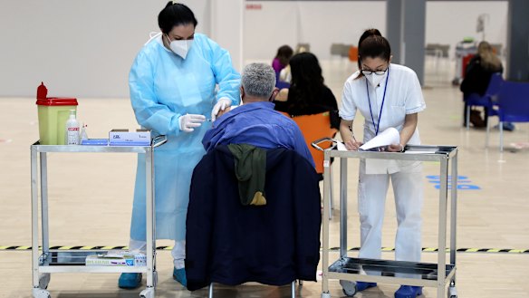A health worker administers the COVID-19 vaccine at a vaccination centre in Rome.