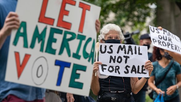 Demonstrators prepare to march to the home of Postmaster General Louis DeJoy on August 15.
