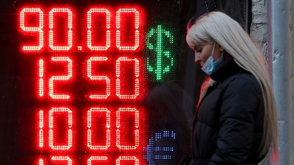 A sign displays foreign currency exchange rates in Moscow this week. The ruble has plunged in face of the economic sanctions put on Russia.