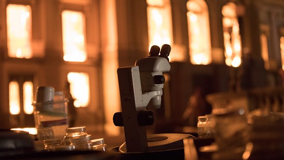 Salvaged equipment lies on the ground as flames engulf the 200-year-old National Museum of Brazil.