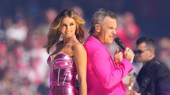 Robbie Williams with Delta Goodrem at the grand final.