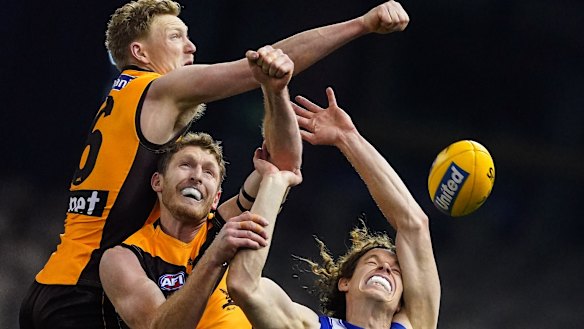 Double-teamed: North forward Ben Brown is kept out of the contest by Hawks defenders James Sicily (left) and Ben McEvoy.