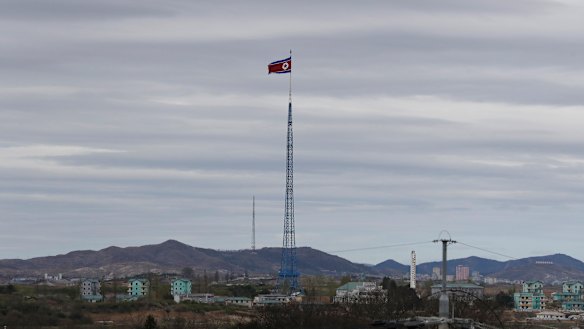 A North Korean flag flutters in the wind atop a 160-metre tower in North Korea.