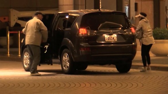 China Innovation Investment officials Xiang Xin and his wife Gong Qing get out of a car at the Grand Hyatt hotel in Taiwan. 