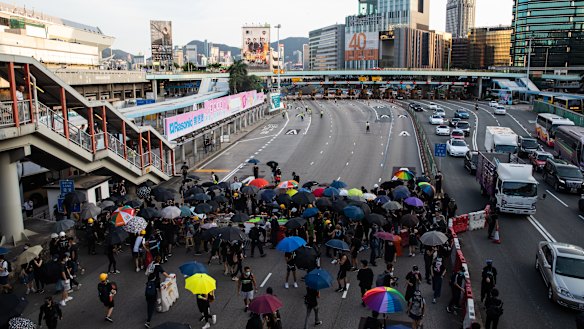 Demonstrators gather to block the Cross Harbor Tunnel.