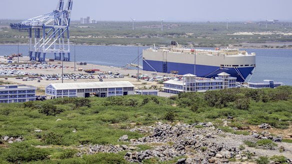 The Grand Aurora vehicle carrier, right, sits moored at Hambantota Port, operated by China Merchants Group, in Sri Lanka.