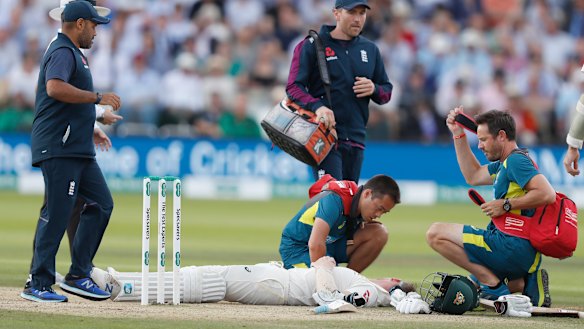 Steve Smith receiving treatment as he lies on the ground after being hit on the head by a ball bowled by England's Jofra Archer.