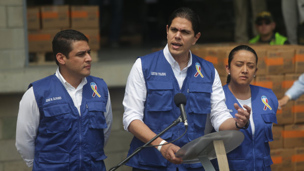 Lester Toledo, an ally of Venezuelan National Assembly leader Juan Guaido, centre, speaks as US humanitarian aid is packaged at a warehouse in Cucuta.