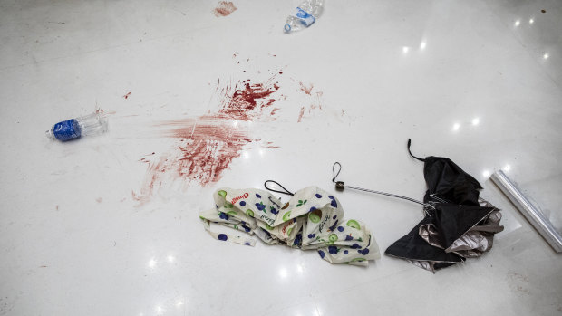 Blood stains are seen next to umbrellas on the ground following the clashes.