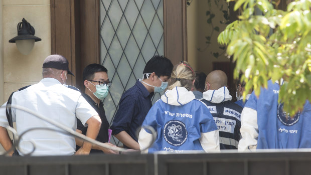 Israeli police workers enter the house of Du Wei after he was found dead in his home in Herzliya, Israel. 