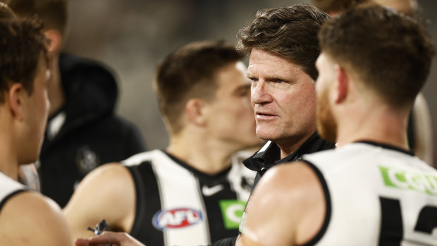 Interim Magpies coach Robert Harvey speaks to his players. 