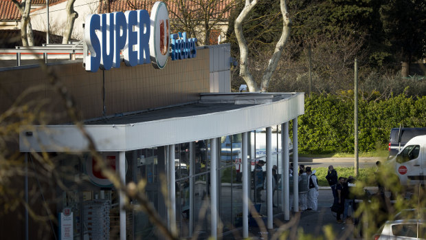 French Police officers and emergency service members work at a supermarket during an incident in Trebes, southern France.