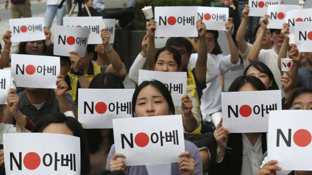 Protesters stage a rally in front of the Japanese embassy in Seoul, South Korea denouncing the Japanese government's decision on their exports to South Korea. The signs read: "No (Japanese PM) Abe."