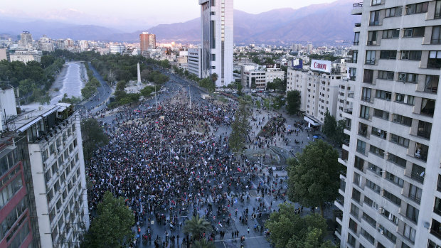 Anti-government protesters gather on Plaza Italia, Santiago, on the day Chileans voted in a referendum to decide whether the country should replace its dictatorship-era constitution.