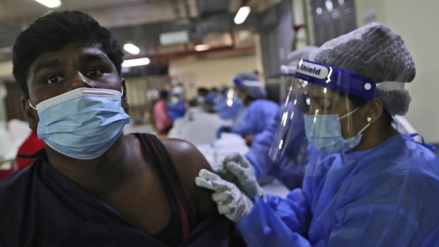 A man receives a Sinopharm COVID-19 vaccine from a medical staffer at the Guru Nanak Darbar Sikh Temple, in Dubai, United Arab Emirates.