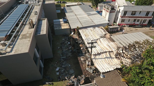 The Flamengo training centre where the young players' dormitory was reduced to piles of ash under a tin roof, centre.