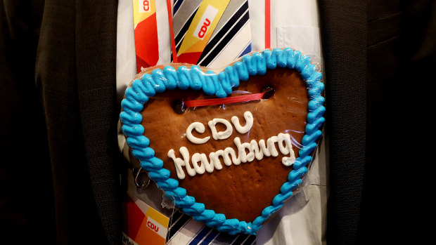 A party member wears a heart-shaped ginger bread cookie necklace during the Christian Democrat Union (CDU) party conference in Hamburg, Germany.
