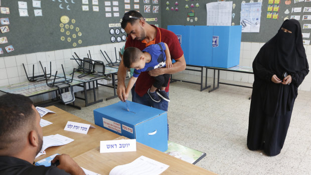Israeli bedouin arabs cast their votes in a polling station in the city of Rahat, Israel.