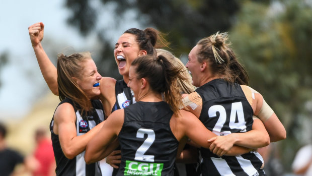 Sharni Layton and teammates celebrate after the Magpies win their 2020 AFLW season opener.