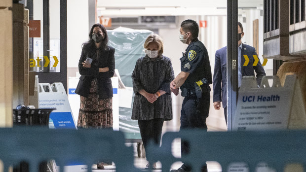 Former first lady and former US Secretary of State Hillary Clinton, middle, exits the University of California Irvine Medical Centre in Orange, California. 