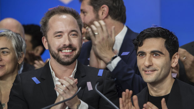 Drew Houston, chief executive officer and co-founder of Dropbox left, and Arash Ferdowsi, co-founder of Dropbox, applaud during the company's initial public offering at the Nasdaq. 