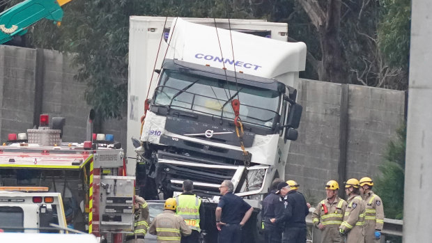 Crash investigators at the scene the day after four police  were struck and killed by a truck on the Eastern Freeway.  