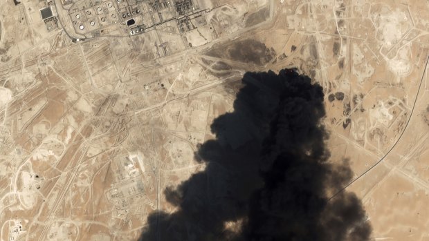 A satellite image shows thick black smoke rising from Saudi Aramco's Abqaiq oil processing facility.