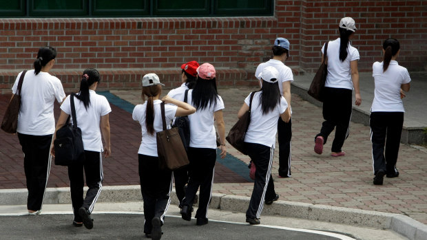 In this 2009 file photo, women who defected from North Korea walk to class at a state-run shelter for defectors.