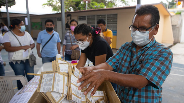 A polling station official counts votes on  in Petaquillas, Mexico, on Sunday.