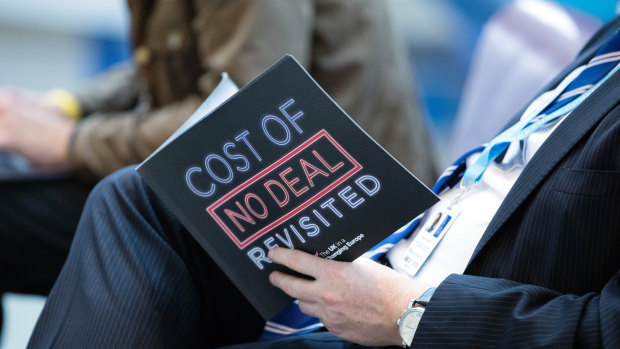 A delegate reads a pro-Brexit document during the Conservative Party annual conference in Birmingham.