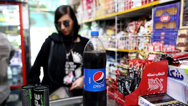 An Iranian customer buys a Pepsi in a grocery store in downtown Tehran. 