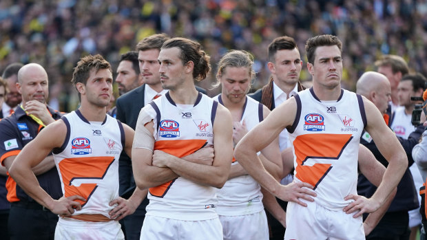A dejected Phil Davis of the Giants (second from left) during the presentations after the 2019 AFL grand final.