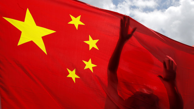 A pro-China supporter holds a Chinese national flag during a rally to celebrate the approval of a national security law for Hong Kong.