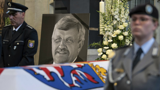 A picture of Walter Luebcke stands behind his coffin during the funeral service in Kassel, Germany in June.