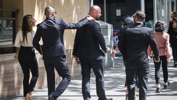 George Daoud, Daniel Gatto and Joseph Mandaliti leave Melbourne Magistrates Court on Monday with two women.