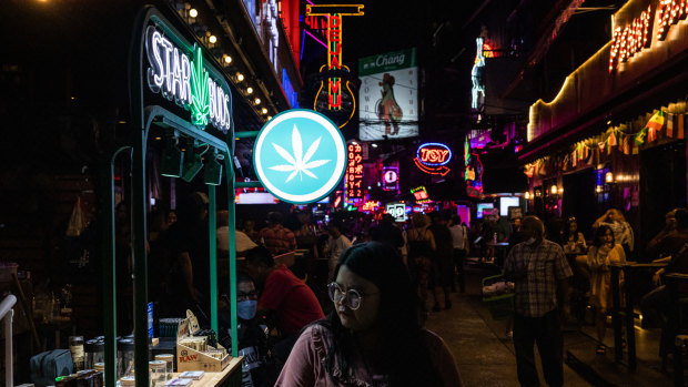 A pedestrian walks past a Star Buds marijuana stand on Soi Cowboy in Asok, Bangkok.