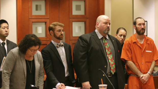 Johnny Bobbitt, in orange, stands during a hearing in New Jersey last year. 