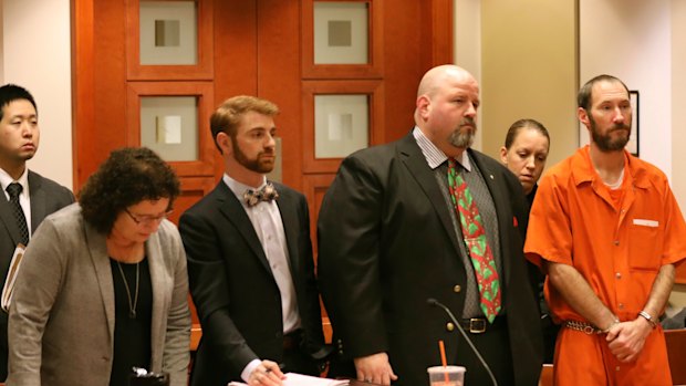 Johnny Bobbitt, in orange, stands during a hearing in New Jersey last year. 