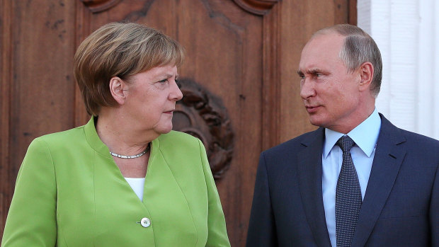 Angela Merkel, Germany's chancellor, left, speaks with Vladimir Putin, Russia's president, during a bilateral meeting at Schloss Meseberg castle in Meseburg, Germany, on August 18.