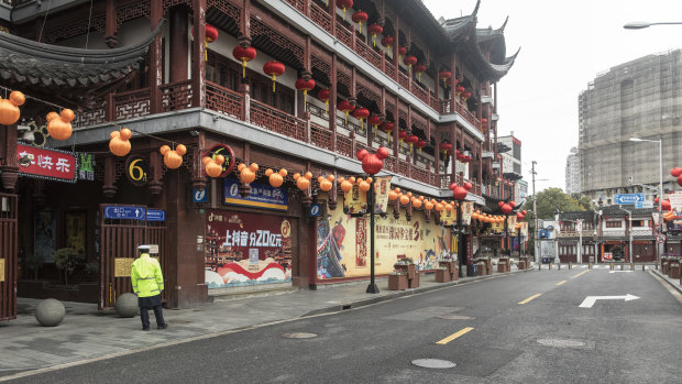 A security guard stands outside the Yuyuan Bazaar in Shanghai.