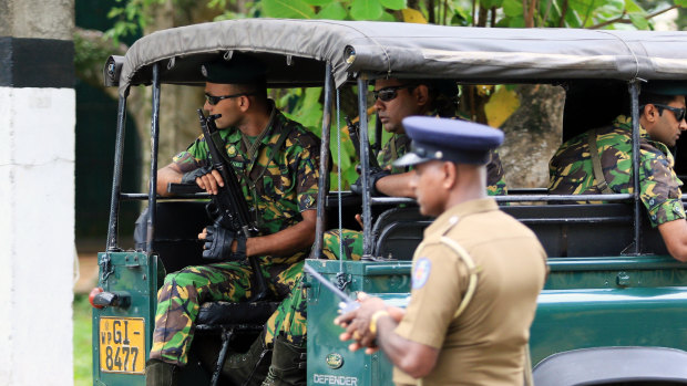 Special Task Force (STF) police officers sit in a vehicle arriving at the Parliament of Sri Lanka in Colombo.