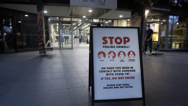 A health notice is displayed at the entrance to a shopping center in the Brunswick suburb of Melbourne. 