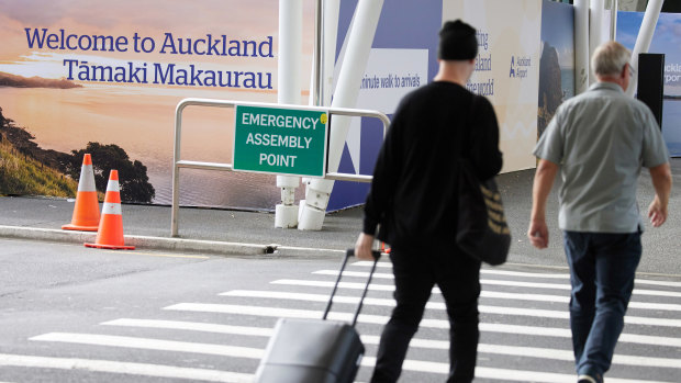 Travelers at Auckland International Airport.