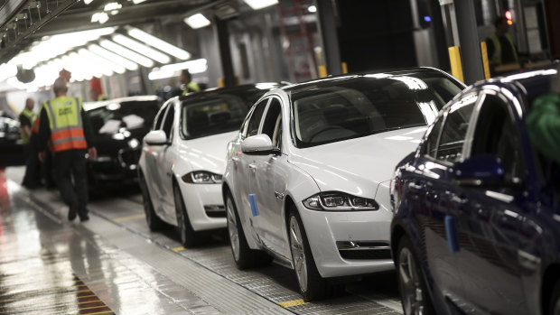 Jaguar automobiles move on a conveyor belt through an assembly plant in Castle Bromwich, UK.