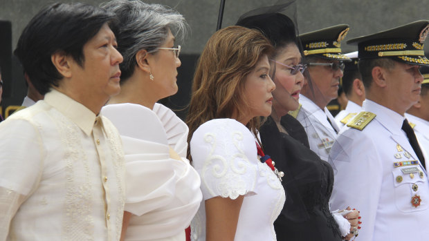 From left: the Marcos children Ferdinand "Bongbong", Irene, Imee and their mother Imelda pay tribute to the flag-draped casket of the late Philippine dictator Ferdinand Marcos at his reburial in 2016.